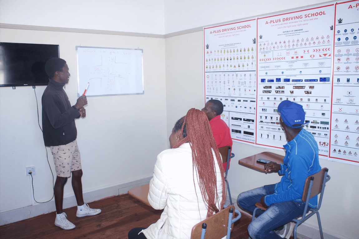 Learners studying road signs and theory