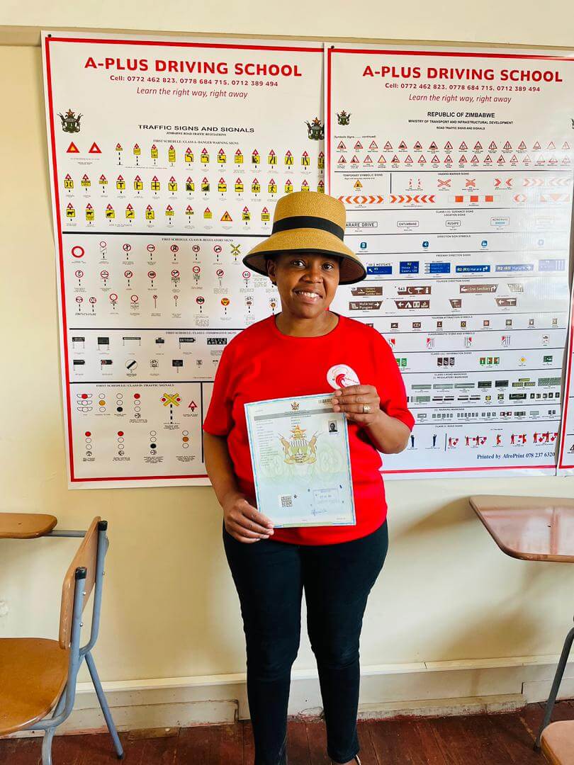 Successful learner holding driving documentation